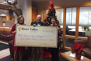 River Valley Bank employees holding a large check