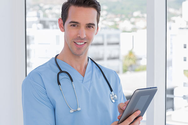 Male doctor holding a digital tablet