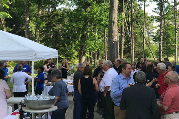 A group of people at outside at the Bay College West Business After Hours event