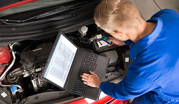 Person working on a car engine