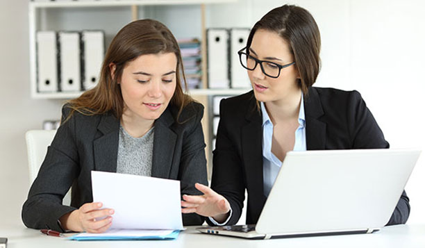Two people reviewing documents