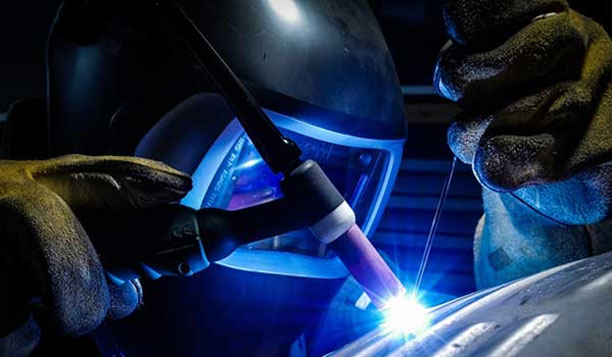 Welder using a torch