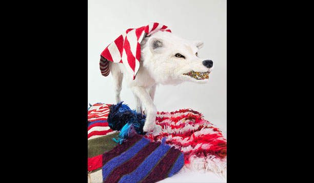 A life-sized needle-felted wolf stalks the gallery space shrouded in a fleece whose bold patterning calls to mind the dazzle camouflage used in the first World War.