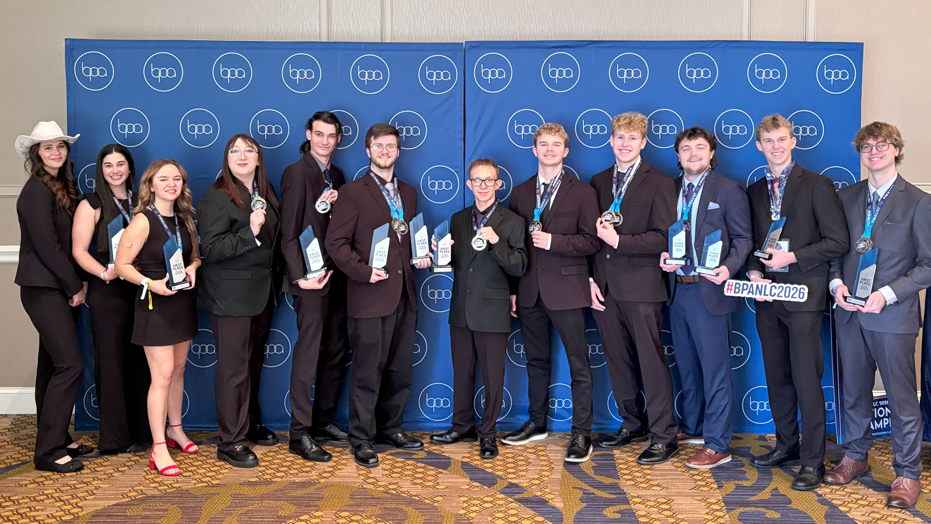 BPA students at the 2026 BPA National Leadership Conference with their awards: Left to Right: Haylee Gatien, Riley Rebholz, Payton Saari, Gracelyn Wiles, Landon (Marcy) Dugree, Matthew Keast, Wyatt Groleau, Jake Poquett, Hunter Robinson, Andrew Lord, Connor Howes, and Gabriel Viau. Not Pictured: Nicholas Chaillier.