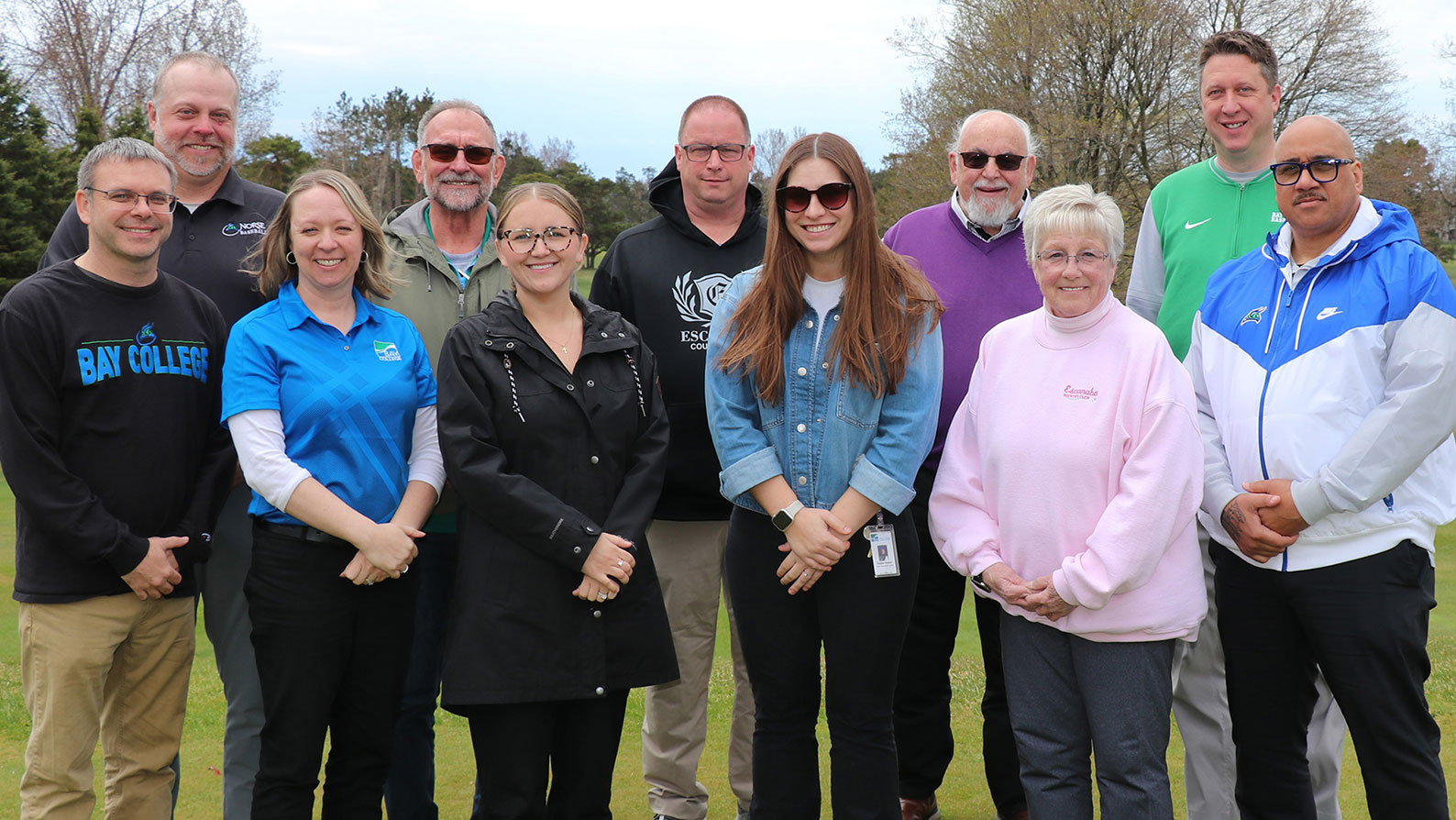 The Bay College Golf Outing Committee standing on the green at the Escanaba Country Club:: Front row (left to right): Dan Porath, Vicki DeGrand, Jalyn Dagenais-Gendron, Kaylee Hubert, Merry Dufresne, James Fassett. Back row (left to right): Mike Pankow, Bill Marmalick, Jon Lancour, Dave Pechawer, Matt Johnson. 