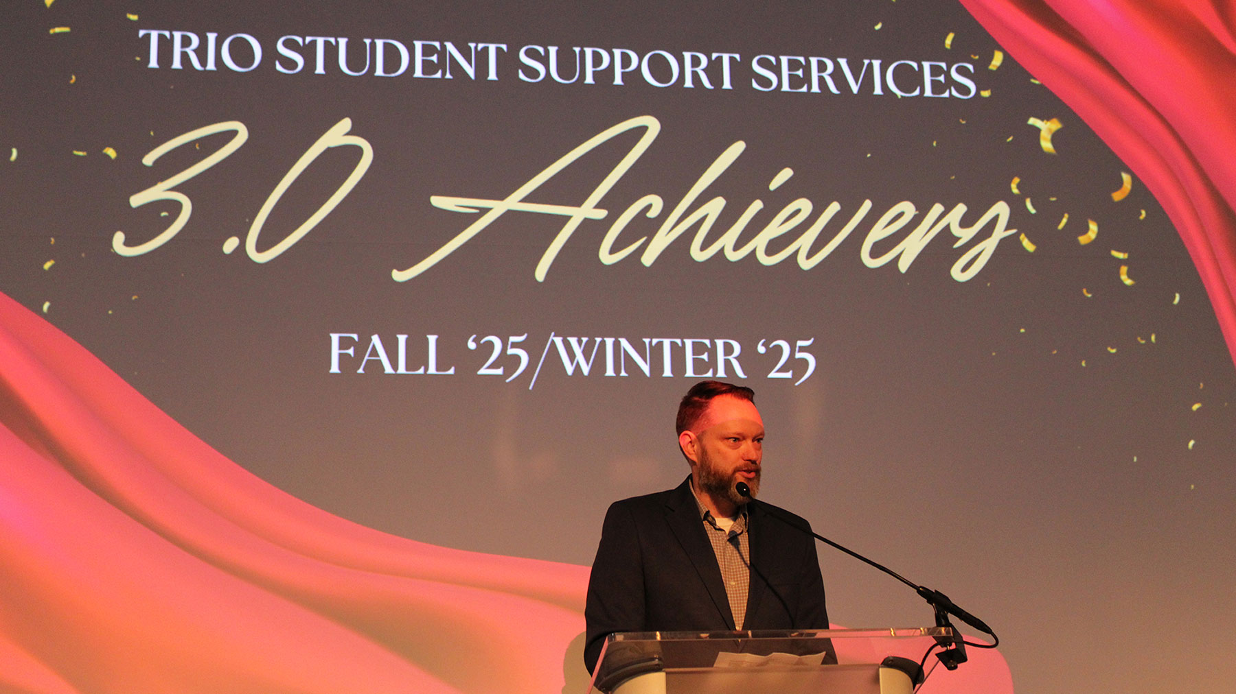 TRIO Director Matt Stewart at the podium congratulating students at the awards dinner.