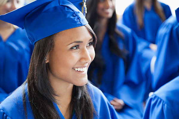 Female graduate wearing a blue graduation cap and gown