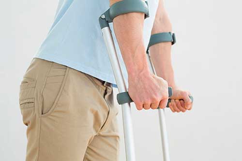 Close up of a man using crutches