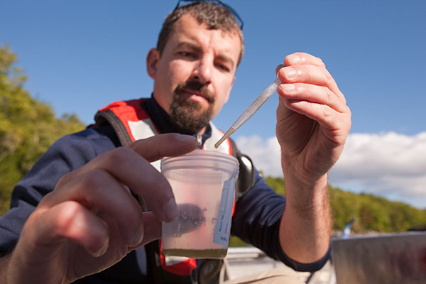 Water specialist collecting samples