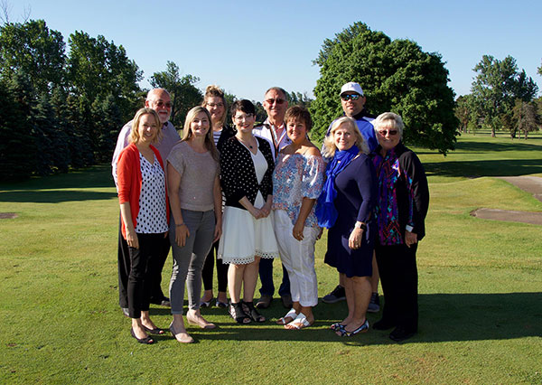 Several members of the golf planning committee are pictured on the golf course.