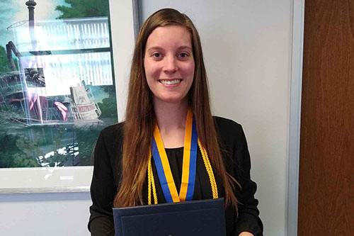 Samantha Henderson holding her diploma