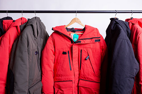 Warm coats hanging on a clothes rack