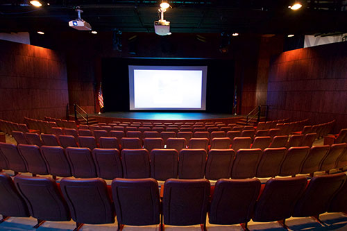 Wide shot of the Besse Theater showing seating and movie screen