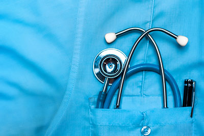 Blue scrubs with medical tools in the pocket