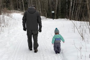 Bob Doepker walking with grandaughter in the woods